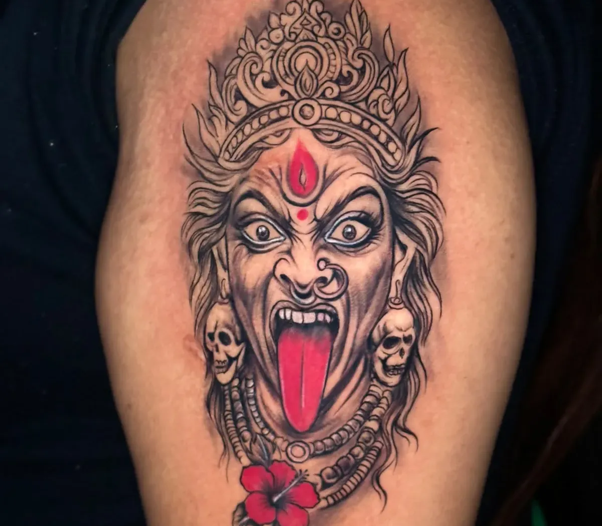 Arjun, lead tattoo artist focused on crafting a custom tattoo in the studio
